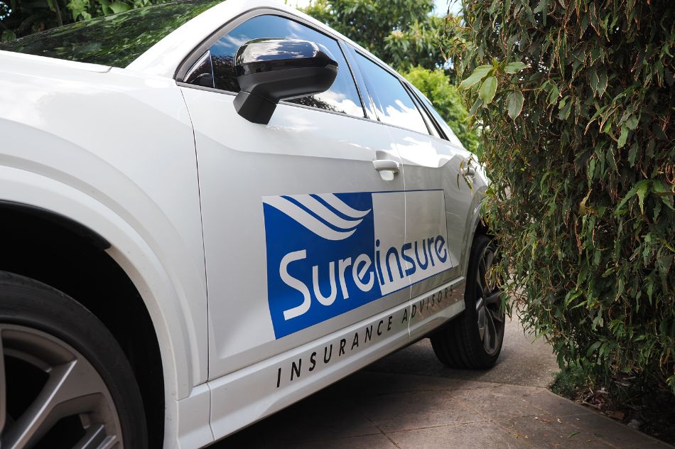 A car with the Sureinsure logo displayed on its side.
