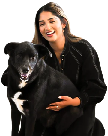 Niki Pokala, General Manager at Sure Insure, smiling with her pet dog in a relaxed outdoor setting